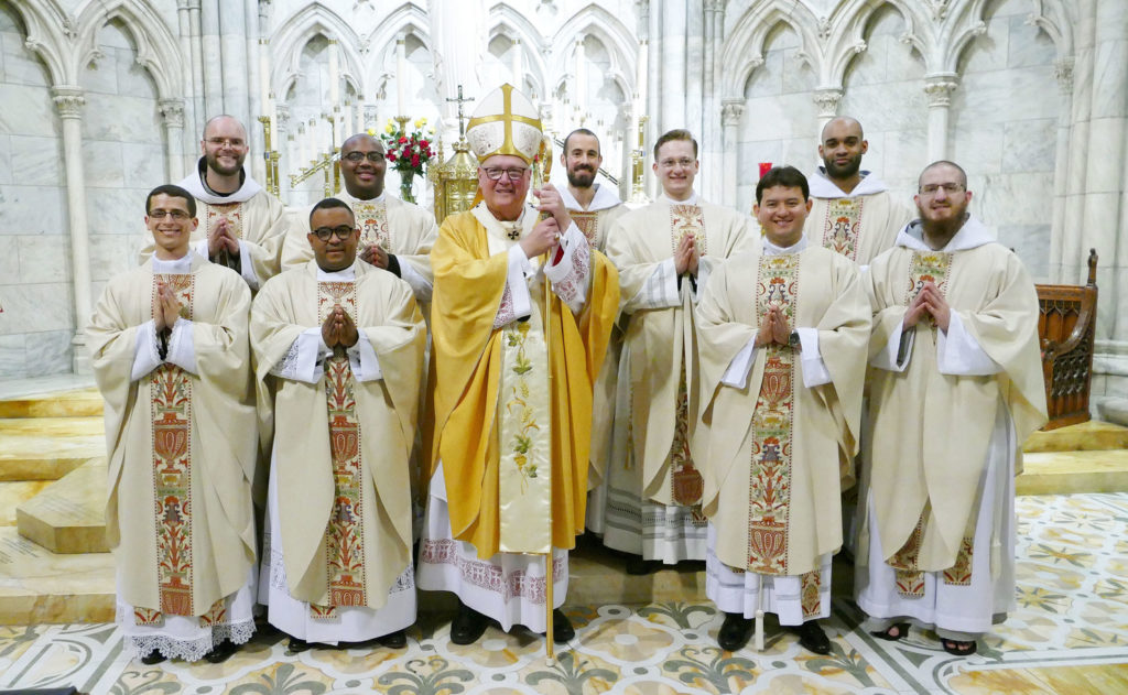 The newly ordained priests join Cardinal Dolan for a group photo in the Lady Chapel after the Mass of Ordination in St. Patrick’s Cathedral May 26. Front row, from left: Father Louis Masi, Father Osvaldo Hernandez, Cardinal Dolan, Father Carlos Limongi and Father Mark-Mary Maximilian Ames, C.F.R. Back row, from left: Father Angelus Montgomery, C.F.R., Father Kareem Smith, Father Francesco Gavazzi, C.F.R., Father Michael Connolly and Father Pierre Toussaint Guiteau, C.F.R. Image courtesy of Catholic New York and copyright Chris Sheridan.