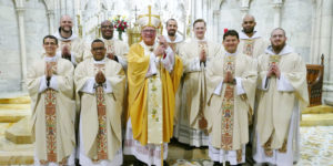 The newly ordained priests join Cardinal Dolan for a group photo in the Lady Chapel after the Mass of Ordination in St. Patrick’s Cathedral May 26. Front row, from left: Father Louis Masi, Father Osvaldo Hernandez, Cardinal Dolan, Father Carlos Limongi and Father Mark-Mary Maximilian Ames, C.F.R. Back row, from left: Father Angelus Montgomery, C.F.R., Father Kareem Smith, Father Francesco Gavazzi, C.F.R., Father Michael Connolly and Father Pierre Toussaint Guiteau, C.F.R. Image courtesy of Catholic New York and copyright Chris Sheridan.