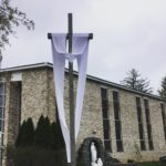 The Easter Sash is on the Crucifix in front of the Blessed Mother Grotto at the Church of the Infant Saviour in Pine Bush, NY.