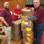 Brother Knights Matt Rommel, Keith Reynolds, and Mike Fenick sorting through the frozen meat boxes in preparation for food distribution to the needy.