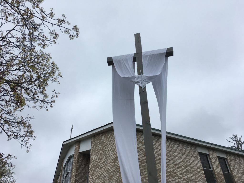 The Easter Sash is on the Crucifix in front of the Blessed Mother Grotto at the Church of the Infant Saviour in Pine Bush, NY.