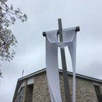 The Easter Sash is on the Crucifix in front of the Blessed Mother Grotto at the Church of the Infant Saviour in Pine Bush, NY.