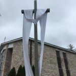 The Easter Sash is on the Crucifix in front of the Blessed Mother Grotto at the Church of the Infant Saviour in Pine Bush, NY.