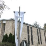 The Easter Sash is on the Crucifix in front of the Blessed Mother Grotto at the Church of the Infant Saviour in Pine Bush, NY.