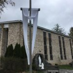 The Easter Sash is on the Crucifix in front of the Blessed Mother Grotto at the Church of the Infant Saviour in Pine Bush, NY.