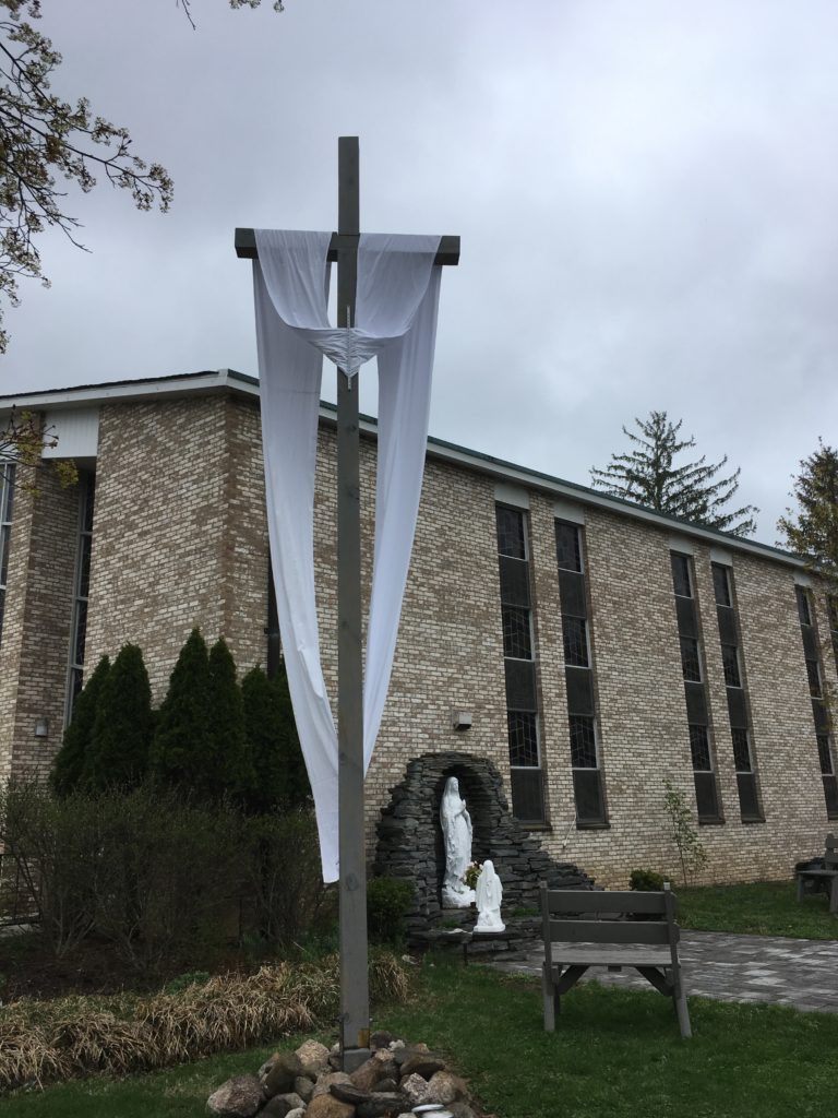 The Easter Sash is on the Crucifix in front of the Blessed Mother Grotto at the Church of the Infant Saviour in Pine Bush, NY.