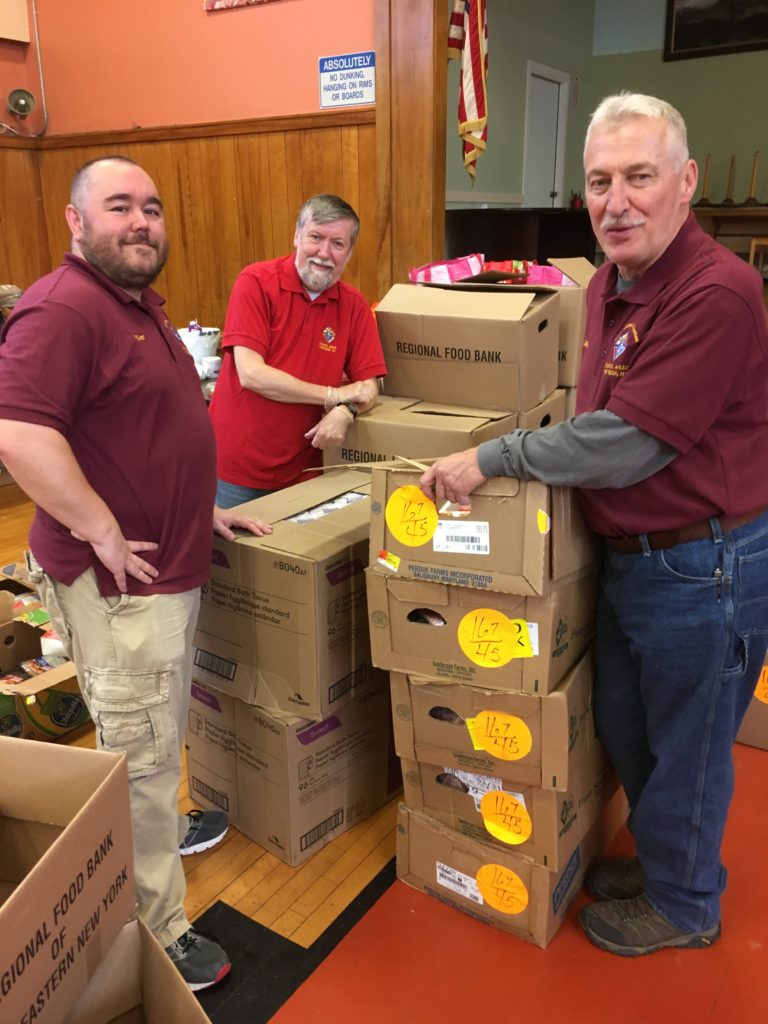 Brother Knights Matt Rommel, Keith Reynolds, and Mike Fenick sorting through the frozen meat boxes in preparation for food distribution to the needy.