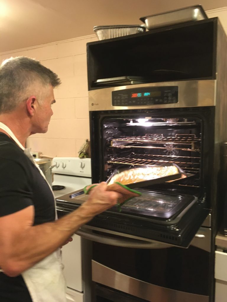 GK Cino pulls a fresh batch of his famous focaccia bread from the oven.